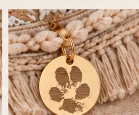 Concept of a gold-tone charm engraved with a paw-print motif